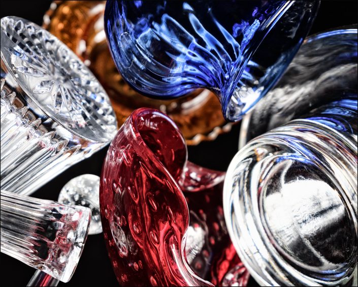 Fourteenth abstract composition from the "An Abyss of Glass" project, a fourteen-image series featuring various glass objects, intricate dynamic highlights and shadows, arranged to create a sense of depth, tension, and visual illusion.