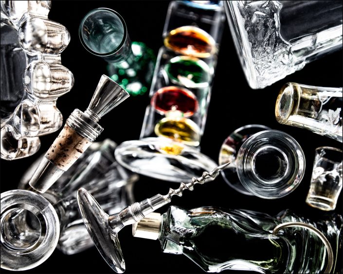 Seventh abstract composition from the "An Abyss of Glass" project, a fourteen-image series featuring various glass objects, intricate dynamic highlights and shadows, arranged to create a sense of depth, tension, and visual illusion.
