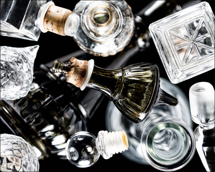 Ninth abstract composition from the "An Abyss of Glass" project, a fourteen-image series featuring various glass objects, intricate dynamic highlights and shadows, arranged to create a sense of depth, tension, and visual illusion.