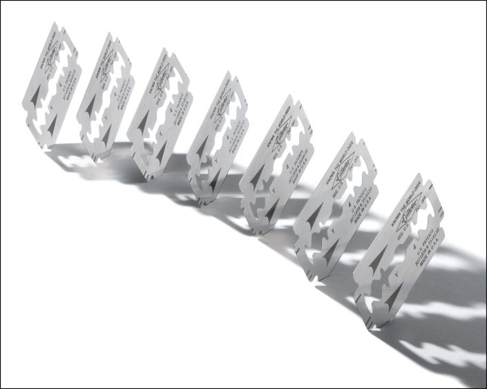 Highlights the interplay of light and shadow through a precise arrangement of razor blades, transforming an ordinary object into a statement of minimalism. Invites viewers to reflect on the balance between contrasting forces and the harmony of form and space.