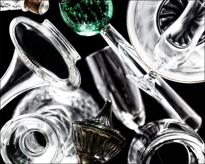 Tenth abstract composition from the "An Abyss of Glass" project, a fourteen-image series featuring various glass objects, intricate dynamic highlights and shadows, arranged to create a sense of depth, tension, and visual illusion.