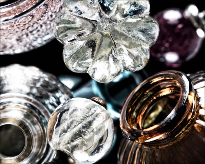 Eleventh abstract composition from the "An Abyss of Glass" project, a fourteen-image series featuring various glass objects, intricate dynamic highlights and shadows, arranged to create a sense of depth, tension, and visual illusion.