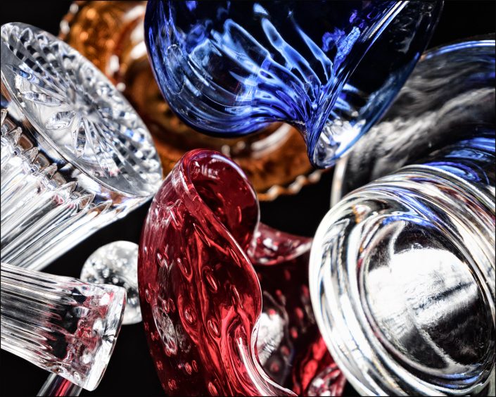 Fourteenth abstract composition from the "An Abyss of Glass" project, a fourteen-image series featuring various glass objects, intricate dynamic highlights and shadows, arranged to create a sense of depth, tension, and visual illusion.