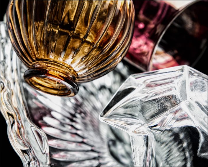 Third abstract composition from the "An Abyss of Glass" project, a fourteen-image series featuring various glass objects, intricate dynamic highlights and shadows, arranged to create a sense of depth, tension, and visual illusion.