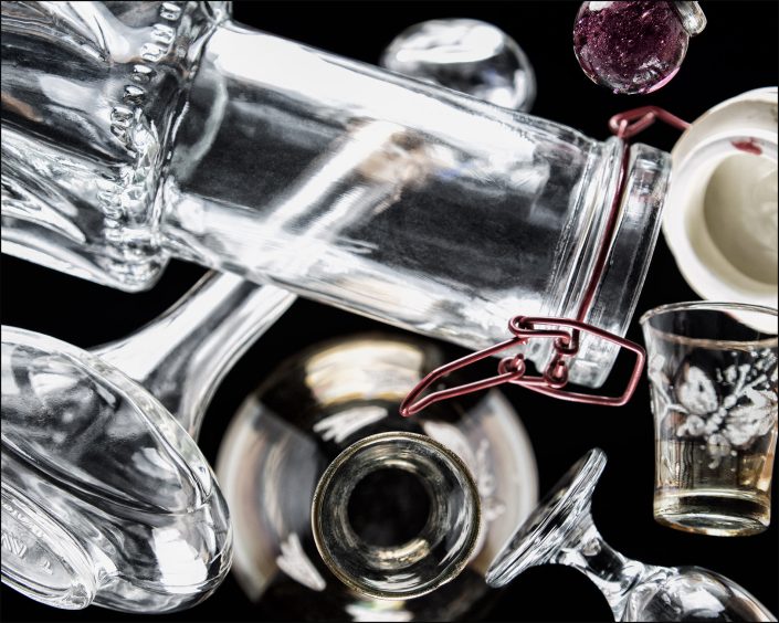 Fifth abstract composition from the "An Abyss of Glass" project, a fourteen-image series featuring various glass objects, intricate dynamic highlights and shadows, arranged to create a sense of depth, tension, and visual illusion.