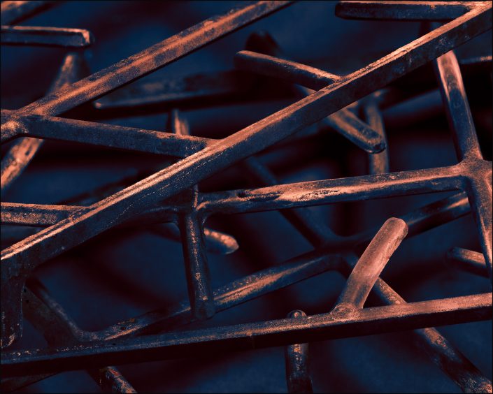 Fine art photograph highlighting rust and oxidation on a set of stove grates. Features rich textures, earthy tones, and dramatic lighting, the image explores decay as a form of natural beauty and visual storytelling through time, transformation, and corrosion.